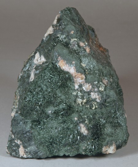 Fairly fine-grained pyroxene-feldspar gneiss in contact with recrystallized masses of medium-grained, dark green actinolite
