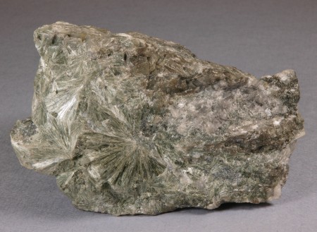 Intergrown radiating masses of pale green, fibrous actinolite with pale gray calcite
