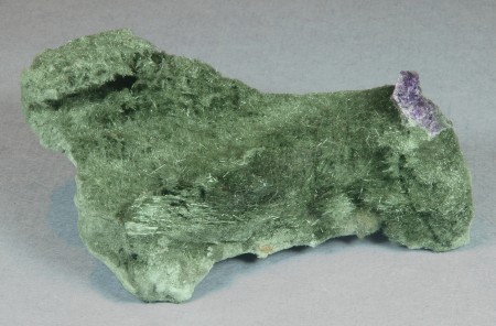 Delicate acicular crystals of green actinolite on a matrix of felted actinolite with minor purple fluorite 