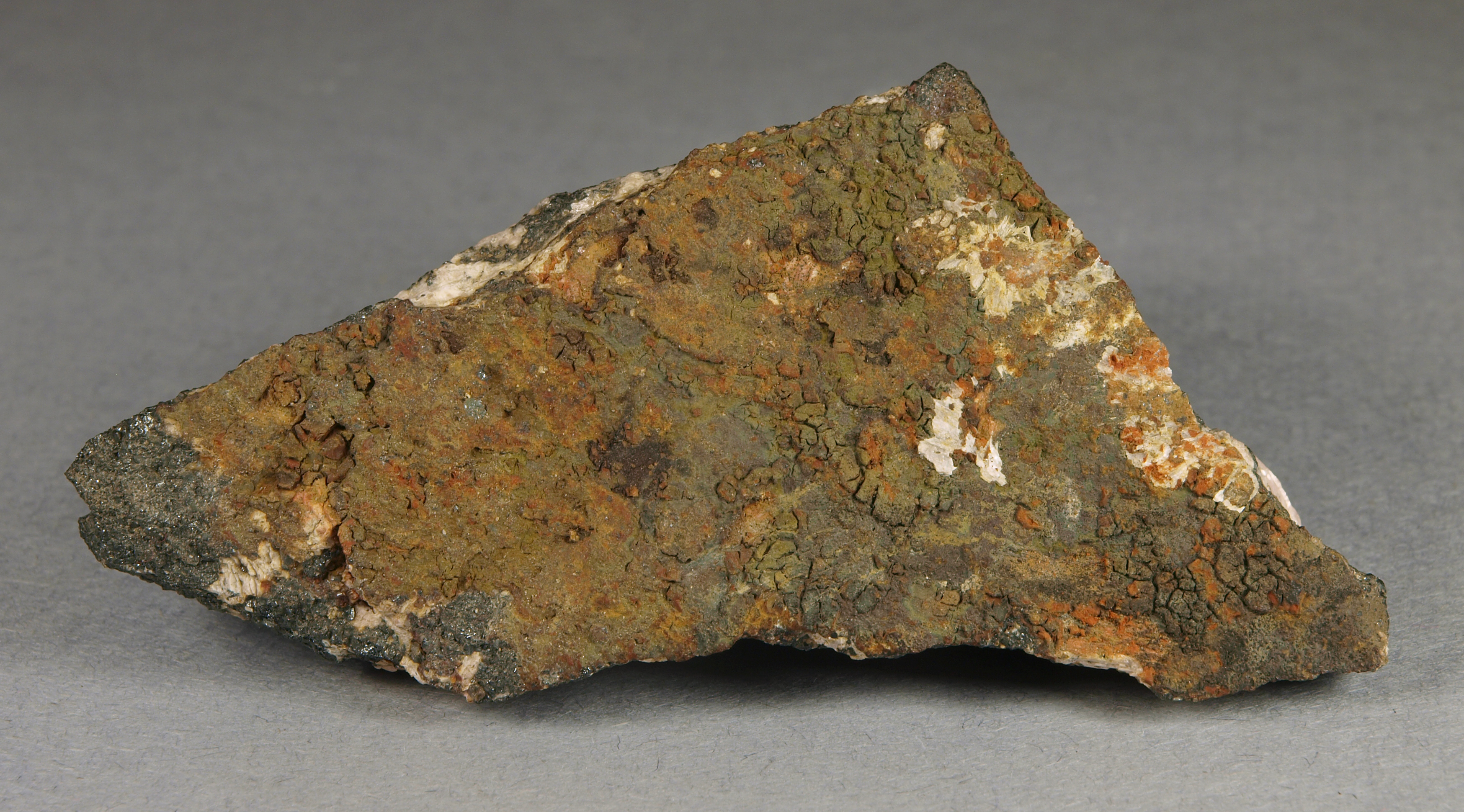Dark olive green adamite, franklinite, willemite, calcite, sphalerite, Sterling mine, Ogdensburg