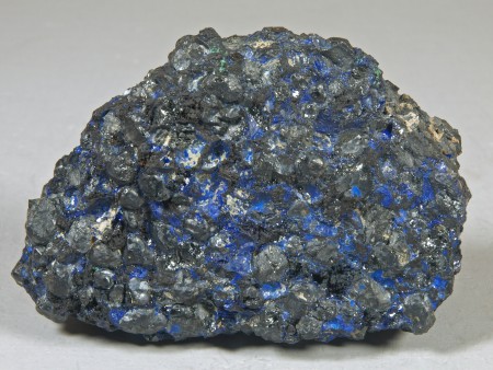 Films and small masses of deep blue azurite in a granular aggregate of residual franklinite