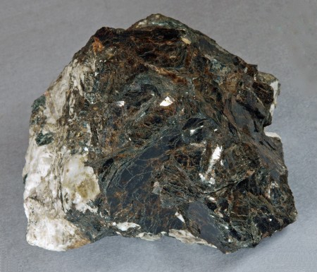 Bannisterite in broad, intergrown, tabular, dark brown crystals of micaceous habit