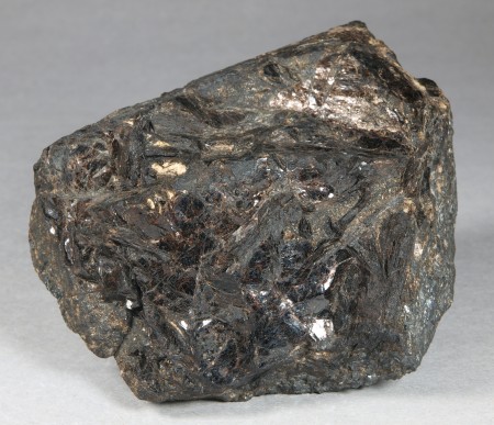 Large, dark brown, intergrown, platy grains of bannisterite