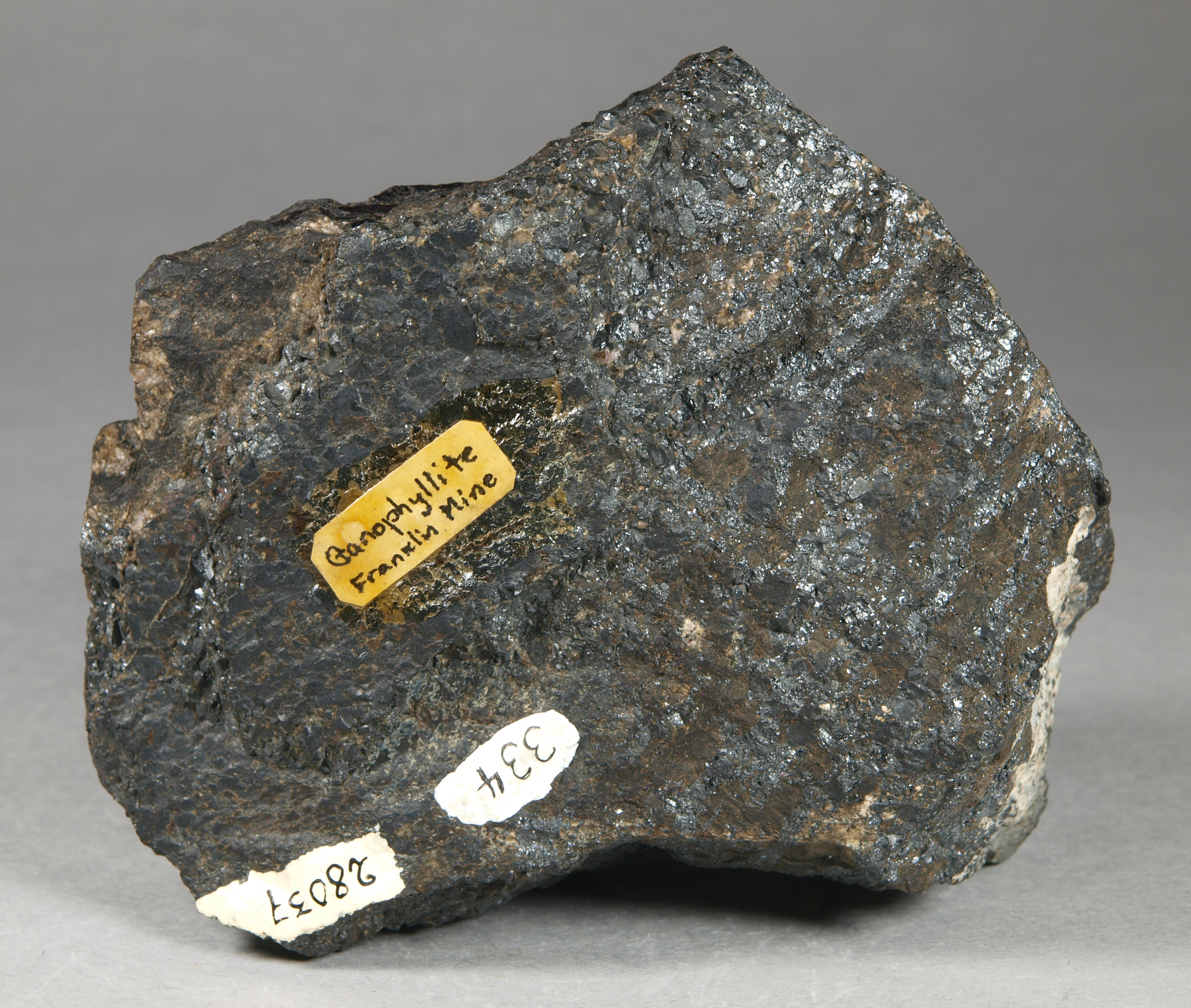 Large, dark brown, intergrown, platy grains of bannisterite