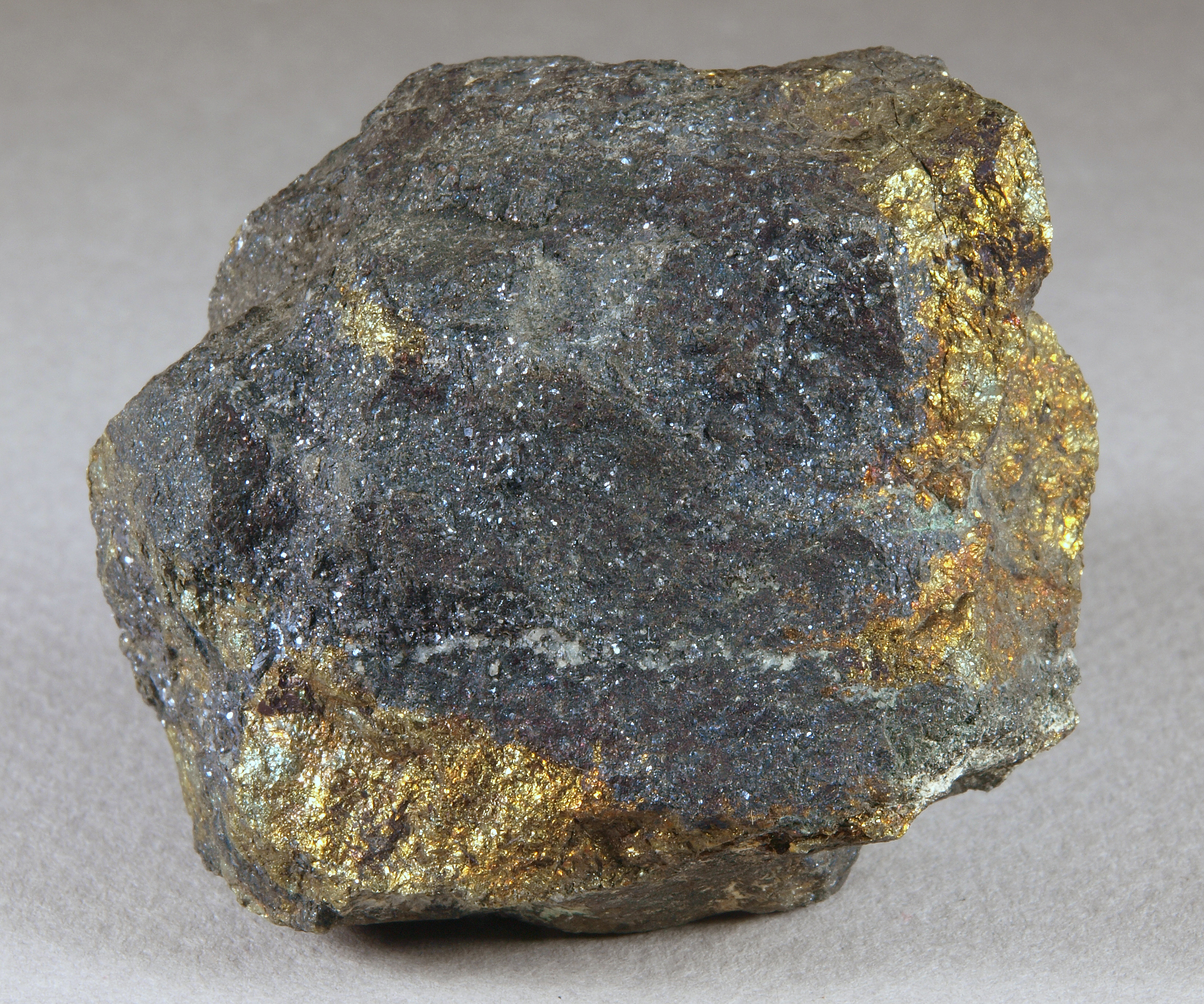 Massive, fine-grained bornite, dark blue to violet, golden-yellow chalcopyrite, pale gray calcite, Franklin mine, Franklin NJ