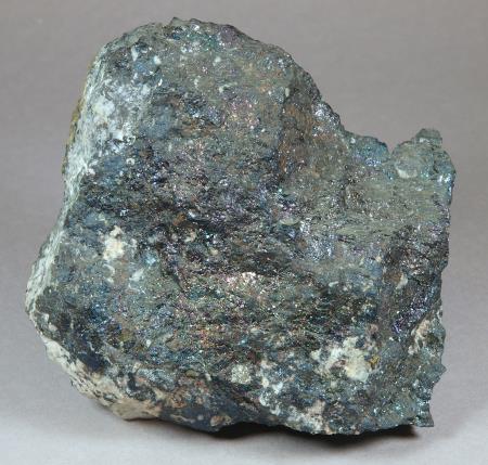 Tarnished bornite, sphalerite and chalcopyrite, granular tephroite, calcite, Sterling mine, Ogdensburg, NJ