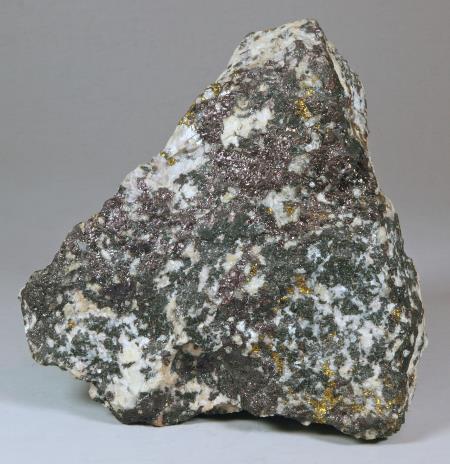 Dark violet blebs of bornite, gold chalcopyrite, white calcite, dark green to brownish-green pyroxene, Sterling mine, Ogdensburg NJ