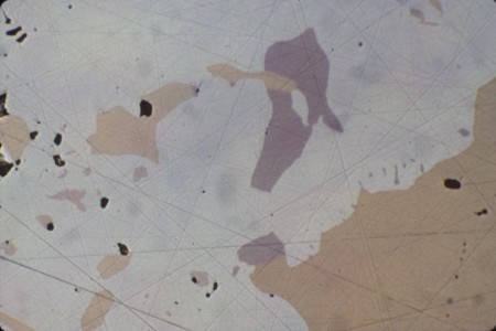 Dendritic mass of nickeline and associated arsenide minerals, tiny, pale violet blebs breithauptite