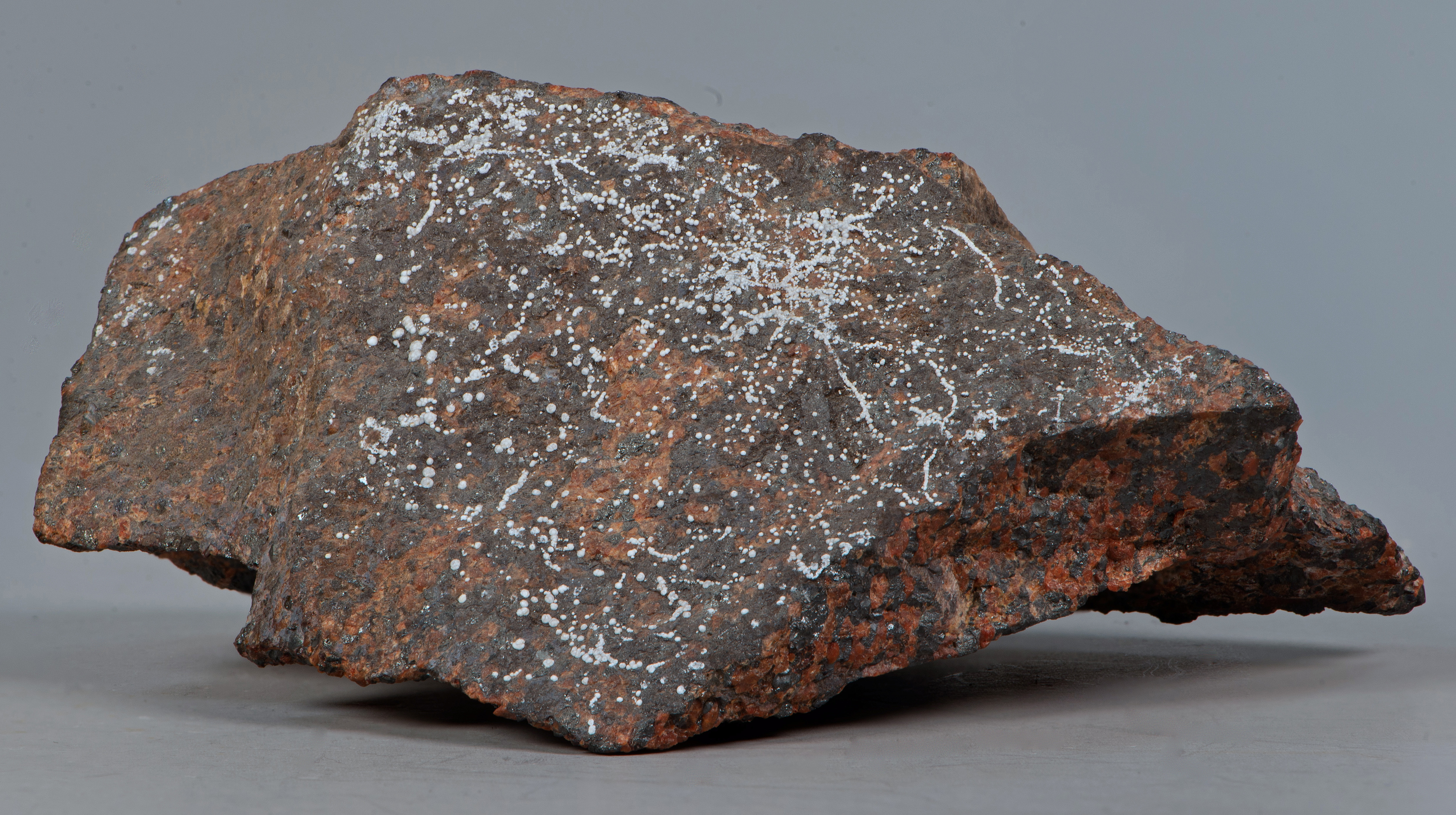 Dypingite in tiny hemispherules, brick-red willemite, franklinite, Sterling mine, Ogdensburg