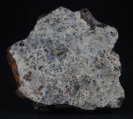 Platelike specimen with submillimeter spheroids of white dypingite