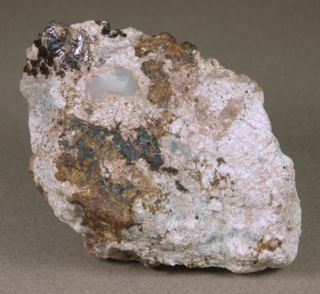 Gypsum, white roeblingite, massive brown andradite, franklinite, brown plates of hendricksite