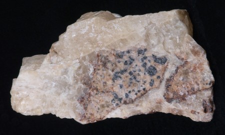 Massive white gypsum cementing altered clasts of granular franklinite-willemite-calcite ore