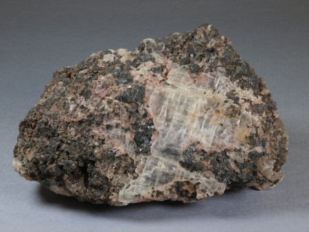 Coarse-grained, transparent, colorless gypsum in vuggy, thoroughly leached, franklinite-calcite ore