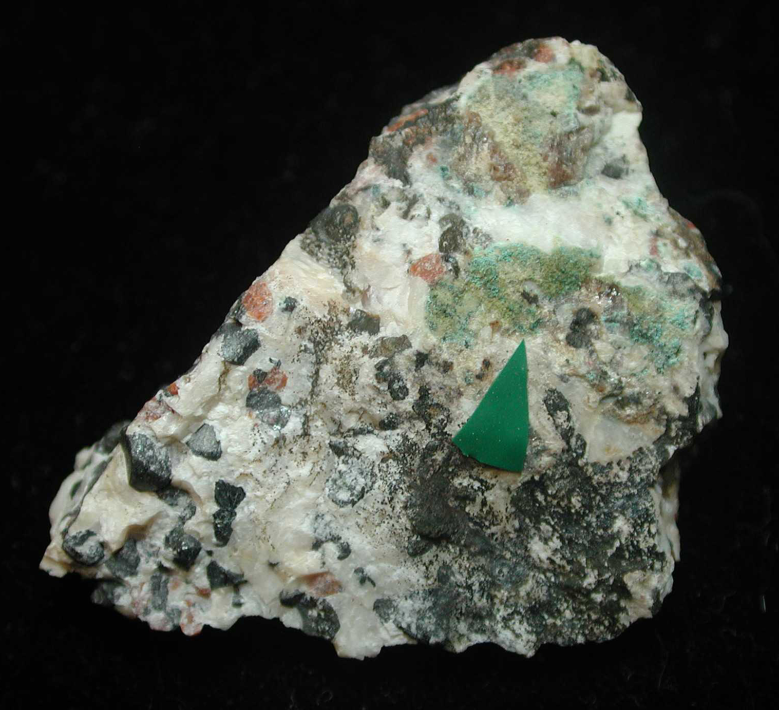 Thin, patchy, pale blue coating of lavendulan, in tiny spheroids on granular willemite-franklinite-calcite ore.