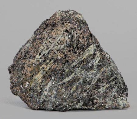 Abundant, pale greenish yellow, bladed, tapering crystals of sillimanite in feldspar-quartz-magnetite gneiss with minor apatite