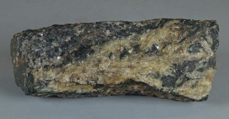 Pale yellow, long-bladed crystals of sillimanite in hornblende-quartz-feldspar gneiss