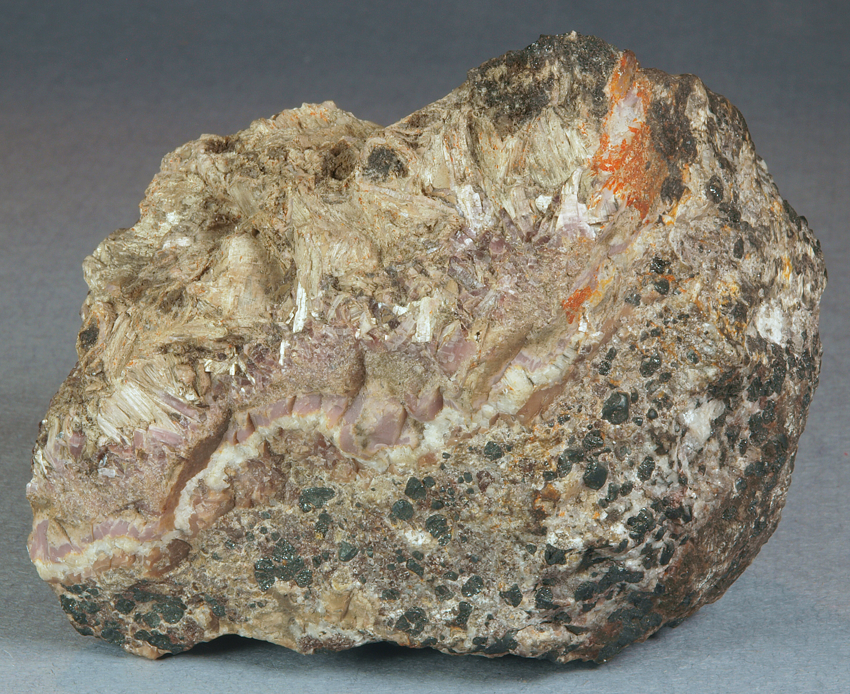 Cherty pinkish-lavender sussexite, calcite, tan fibrous sussexite, zincite, pyrochroite, Sterling mine, Ogdensburg