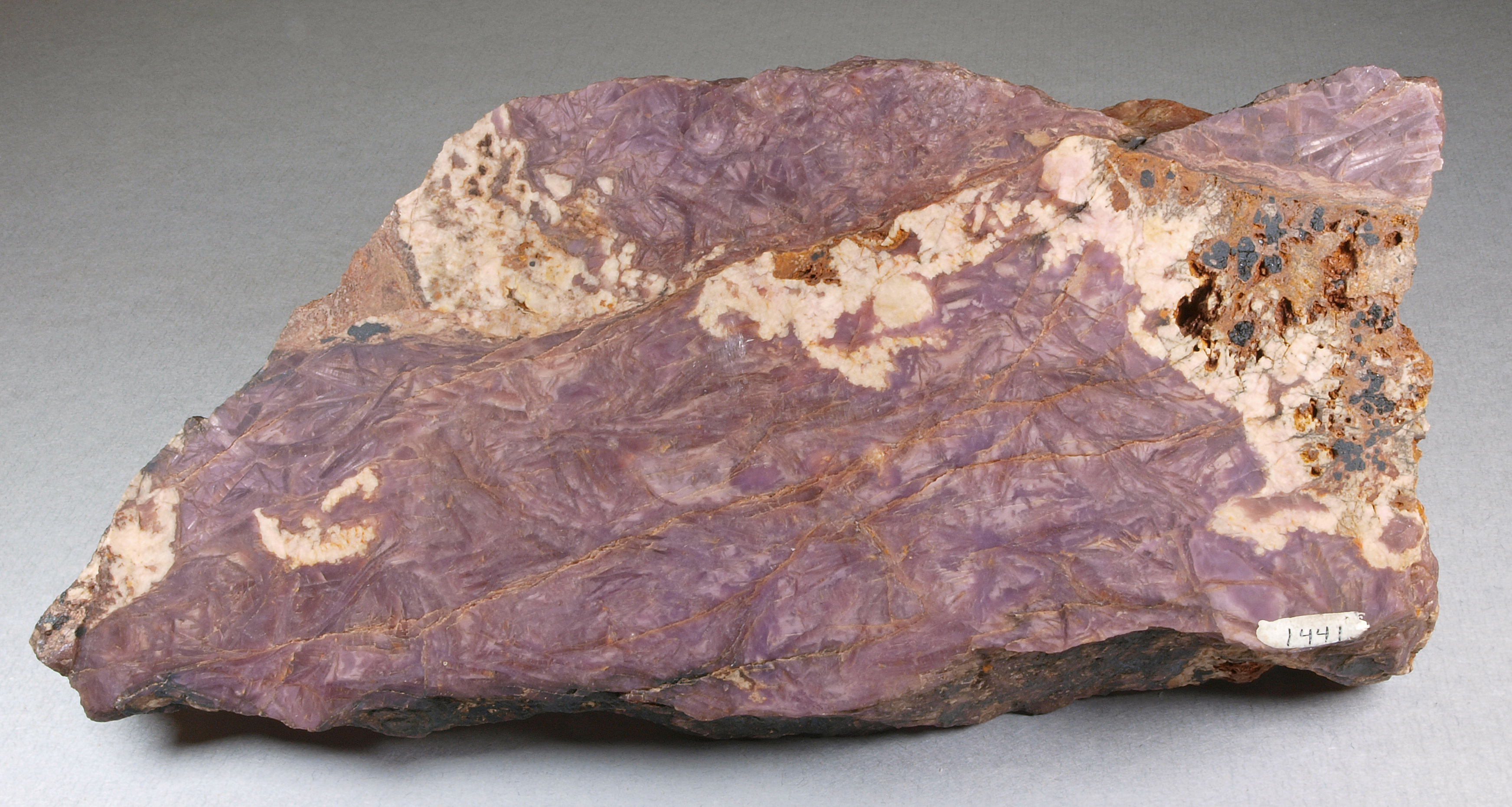 Purplish sussexite, brownish orange zincite, white calcite, Sterling mine, Ogdensburg