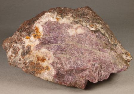 Purplish sussexite with orange zincite, bordered by calcite, Sterling mine, Ogdensburg