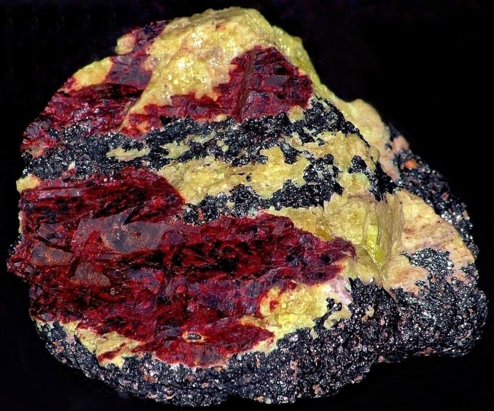 Yellow willemite, gemmy in areas, red zincite and franklinite