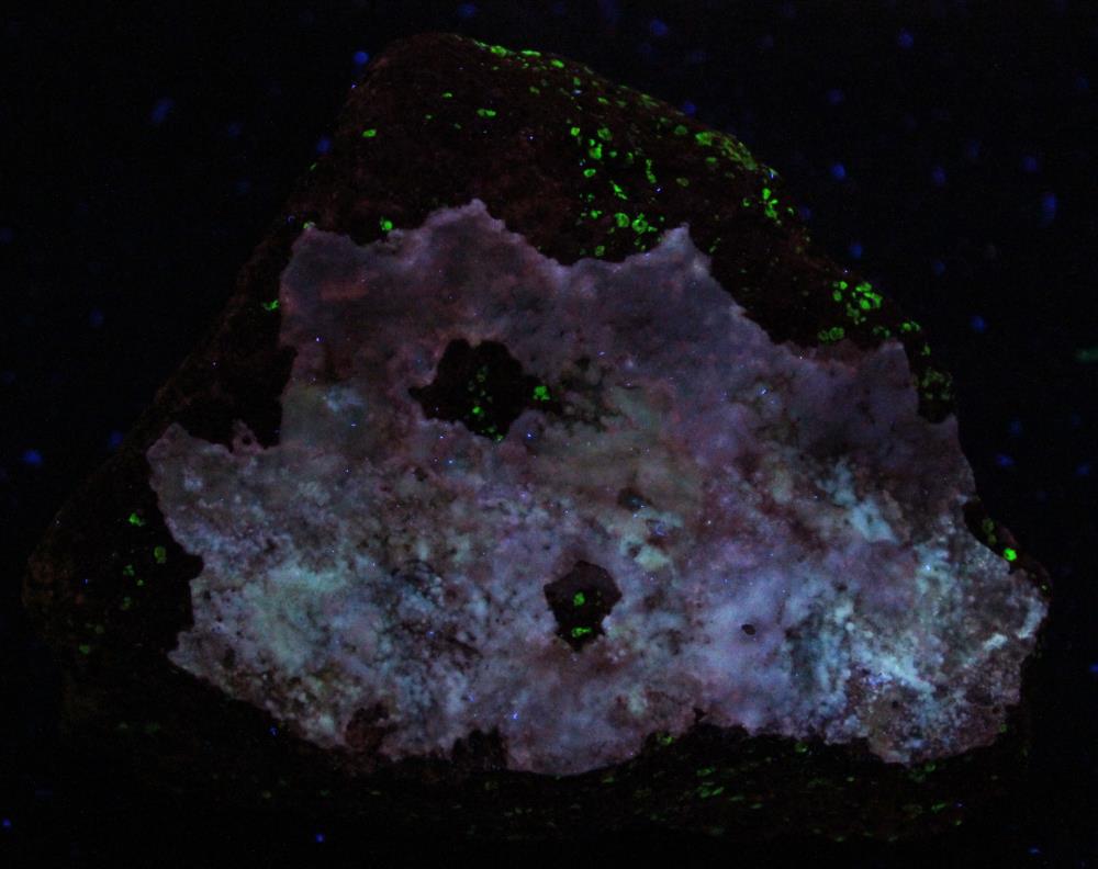 Aragonite coating on calcite / willemite /  franklinite ore, Buckwheat Dump Franklin under longwave UV Light