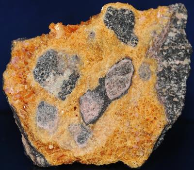Axinite-(Mn) ( non-fluorescent), rhodonite, willemite and franklinite from Franklin, NJ.
