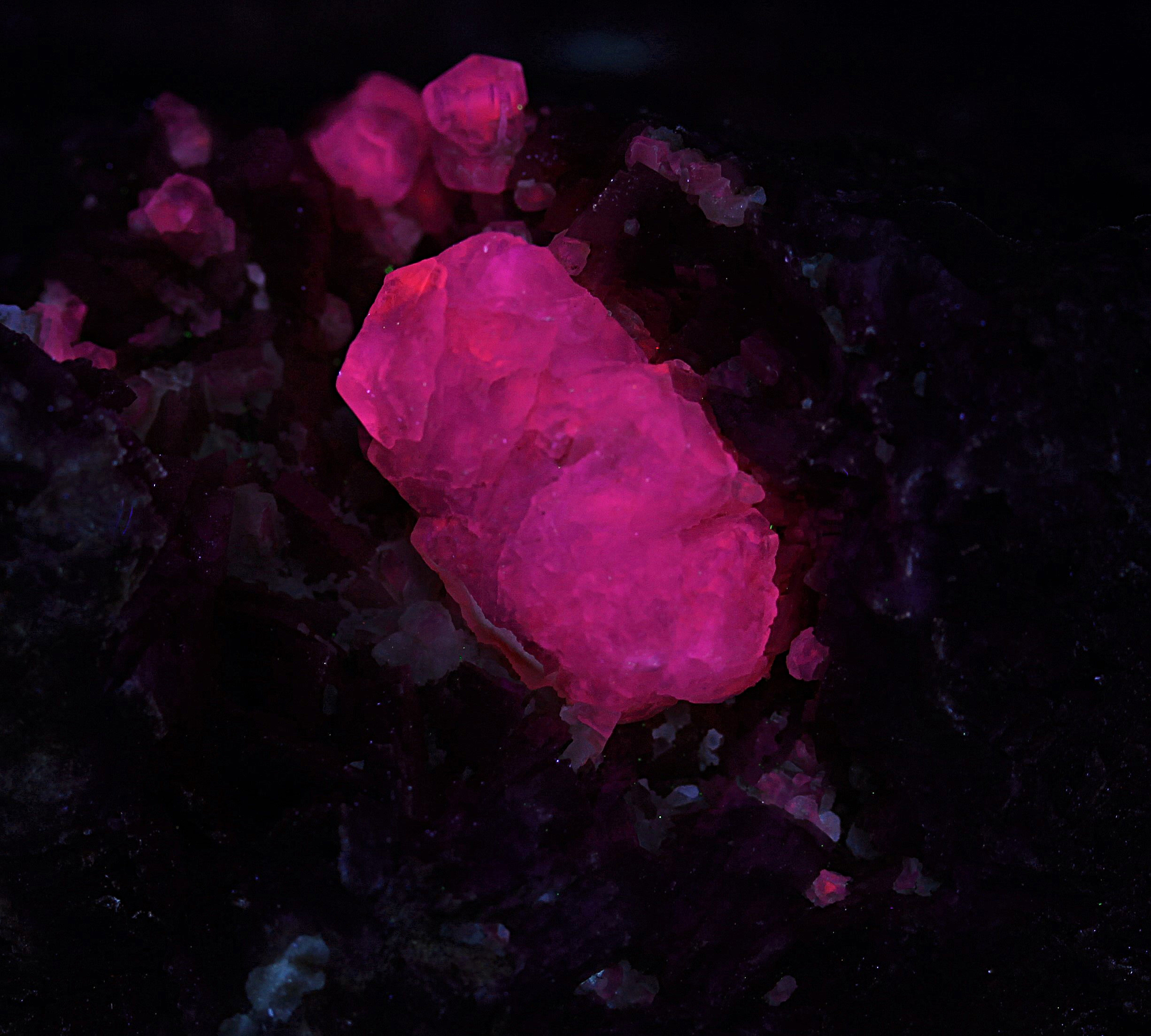 Calcite crystals, dolomite with carbonate coating from the Lang Shaft, Franklin, NJ  under midwave UV Light