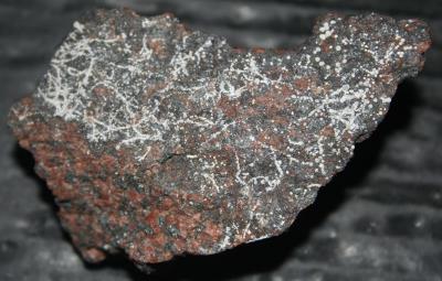 Dypingite micro-mineral spheres on red willemite / franklinite ore, image width 2 inches