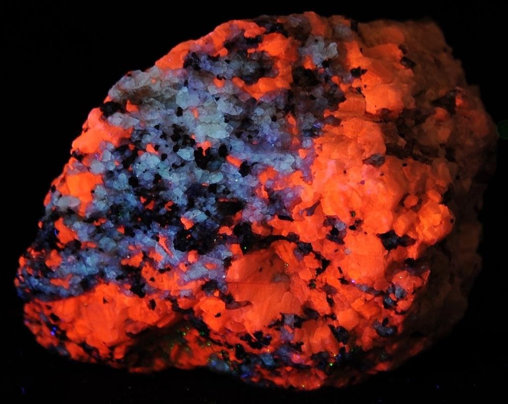 Fluorite, calcite and franklinite from Franklin, NJ under shortwave UV Light