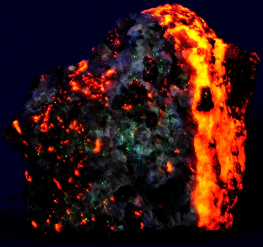 Fluorite, calcite, garnet from Franklin, NJ. under shortwave UV Light