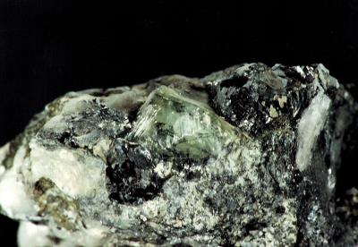Genthelvite (gemmy) in calcite and franklinite matrix from Sterling Hill Mine, NJ