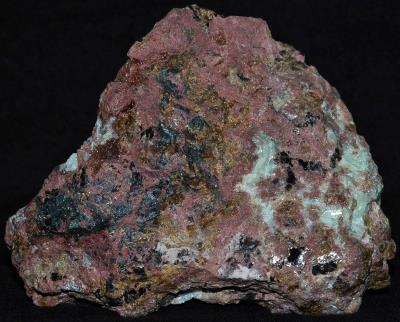 Hancockite (brick red), franklinite, andradite garnet, willemite and minor hendricksite mica from Franklin, NJ
