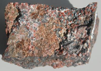 Mcgovernite mineral coating on calcite, zincite and franklinite from Sterling Hill, NJ.