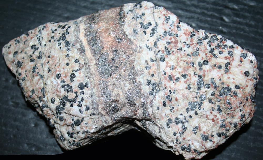 Sphalerite vein in willemite, calcite, franklinite ore from Sterling Hill, NJ.
