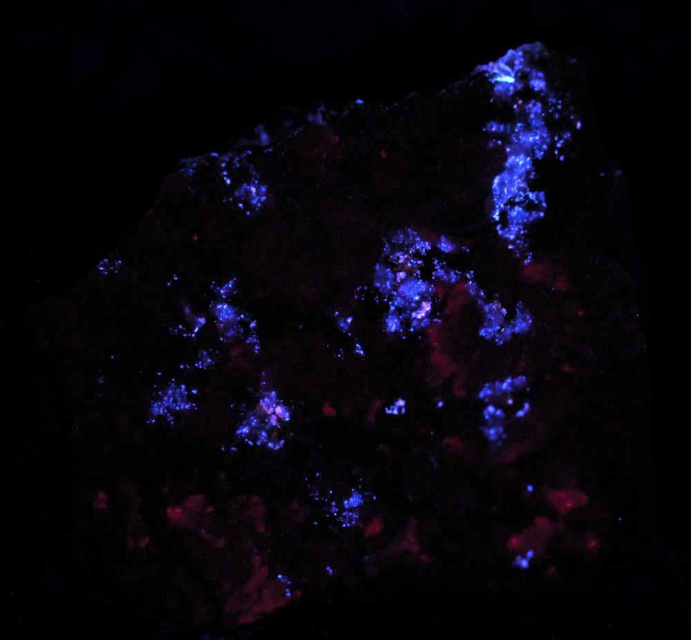 Sphalerite, microcline feldspar, minor willemite from the Buckwheat dump Franklin, NJ under longwave UV Light