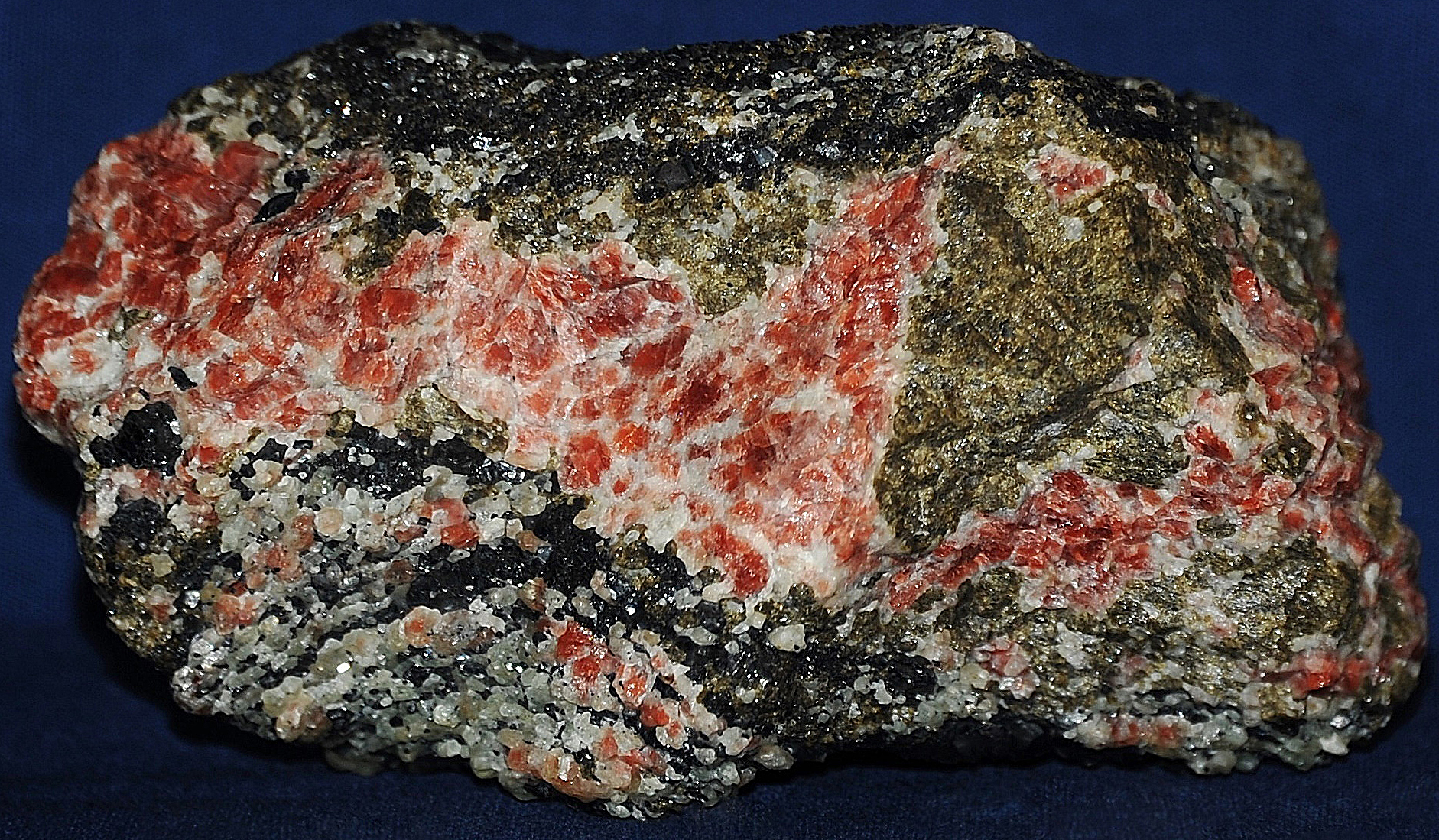 Red willemite, green andradite garnet and franklinite from Franklin, NJ
