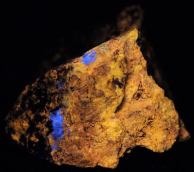 Wollastonite "fibrous" and margarosanite, from Franklin, NJ under shortwave UV Light